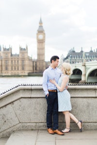 an engaged couple posing in front of big ben in london