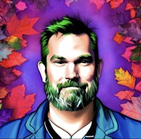 a portrait of a man with a beard in front of colorful leaves
