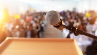 a microphone in front of a crowd of people