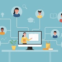 a group of people sitting at a desk with a computer connected to them