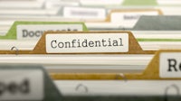 a stack of folders with the word confidential on them
